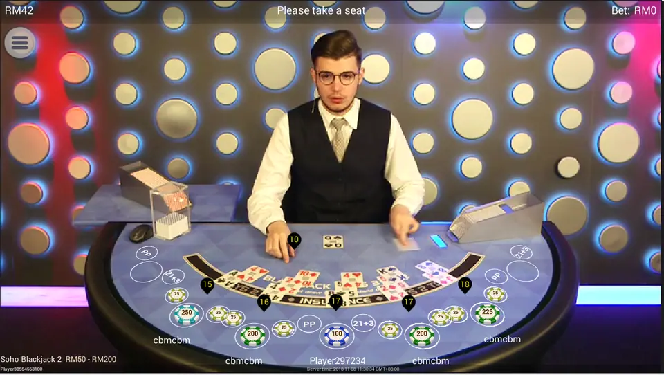 Soho Blackjack 2 on NTC33 with a dealer in a waistcoat, chips on most seats and hand totals shown next to each